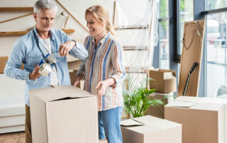 Senior couple packing to move into senior living community