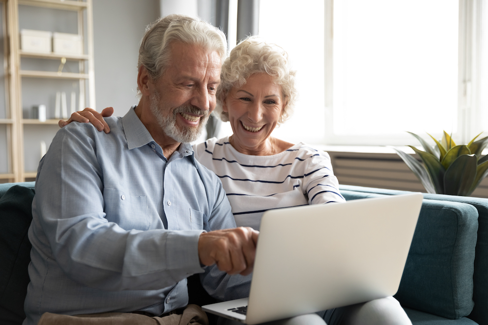 A senior couple video chatting on their computer at the assisted living facilities in Canton, MI