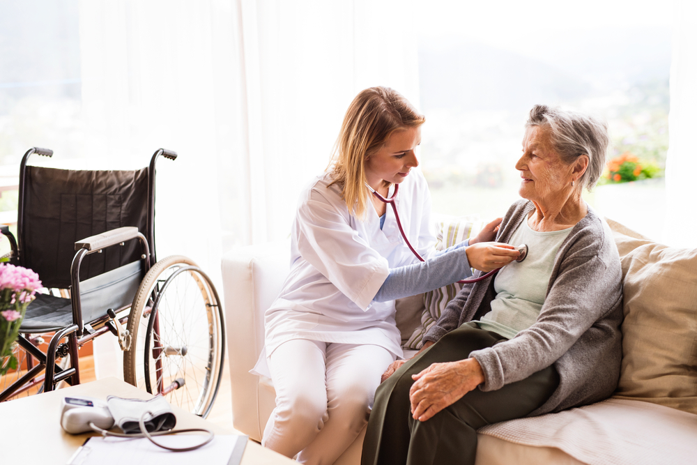 Senior woman getting heart checked out by medical professional at best senior living communities in mi