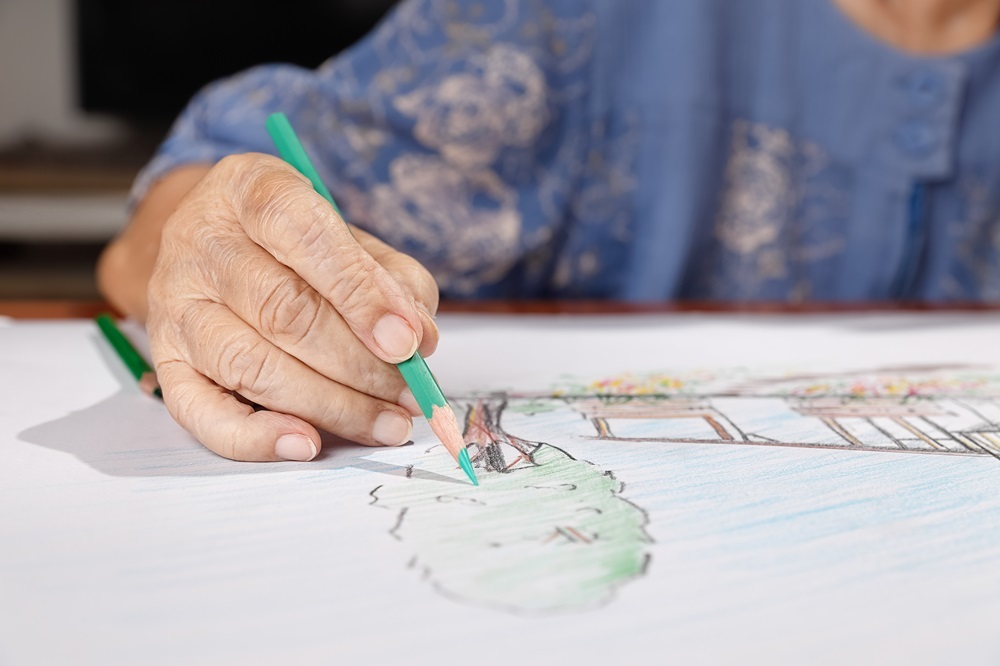 A dementia senior living resident coloring as a part of art therapy