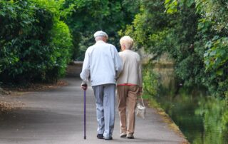 A senior couple goes for a nature walk around their dementia senior living