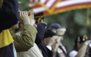 Veterans saluting the American flag in senior living in Canton, MI