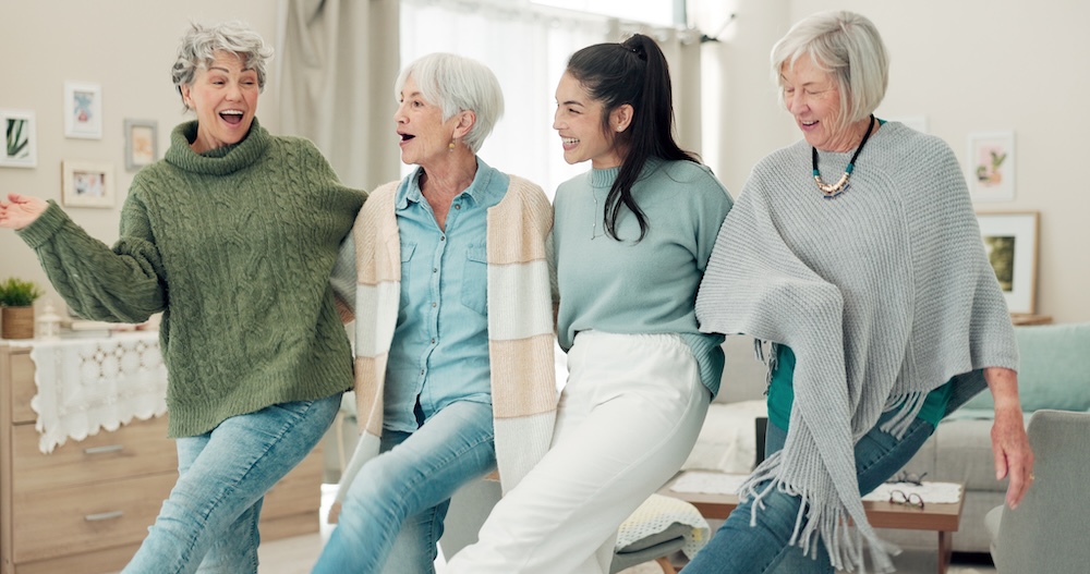 senior woman and caregiver having fun and receiving assisted living help for seniors 